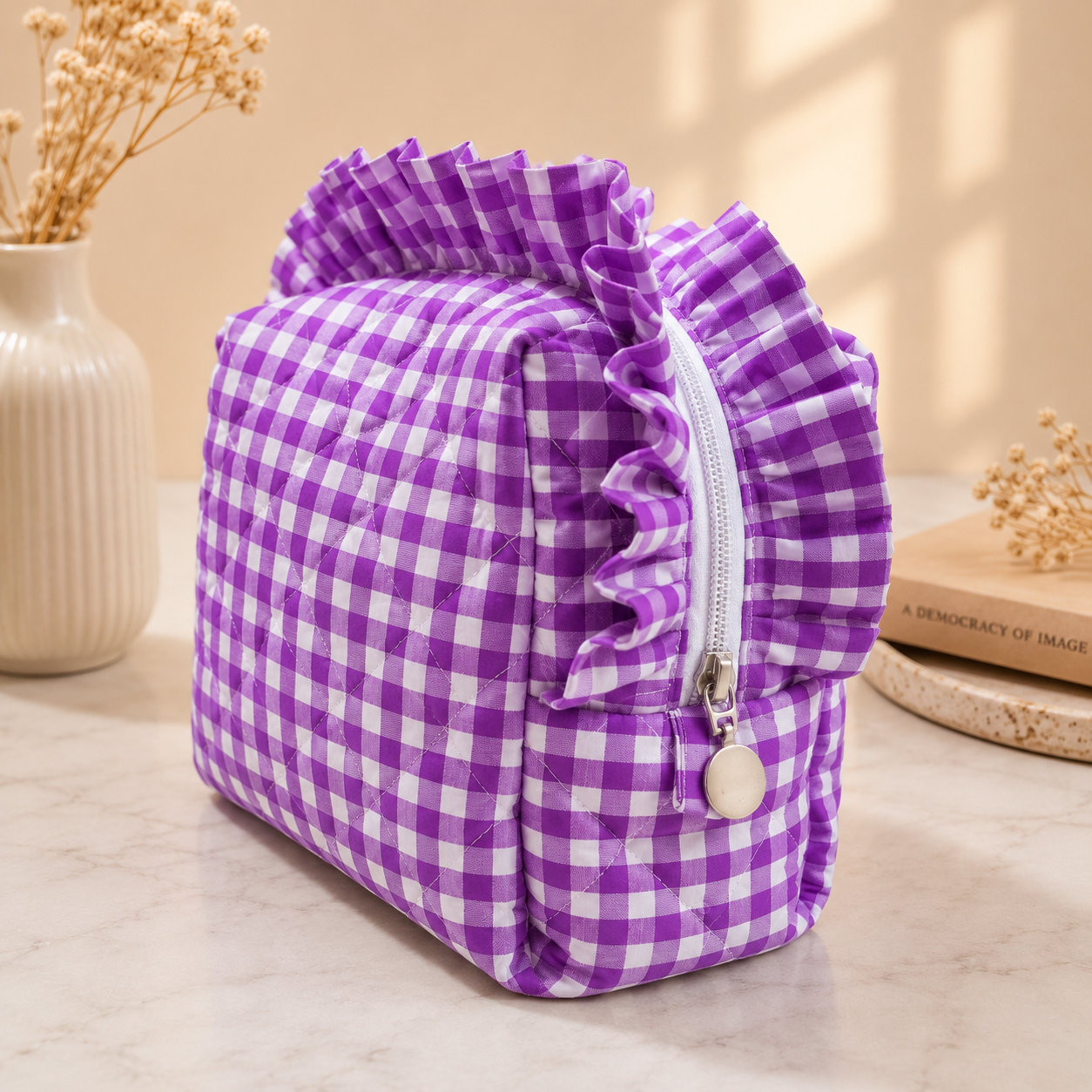 Purple gingham-patterned pouch with ruffles on a neutral background
